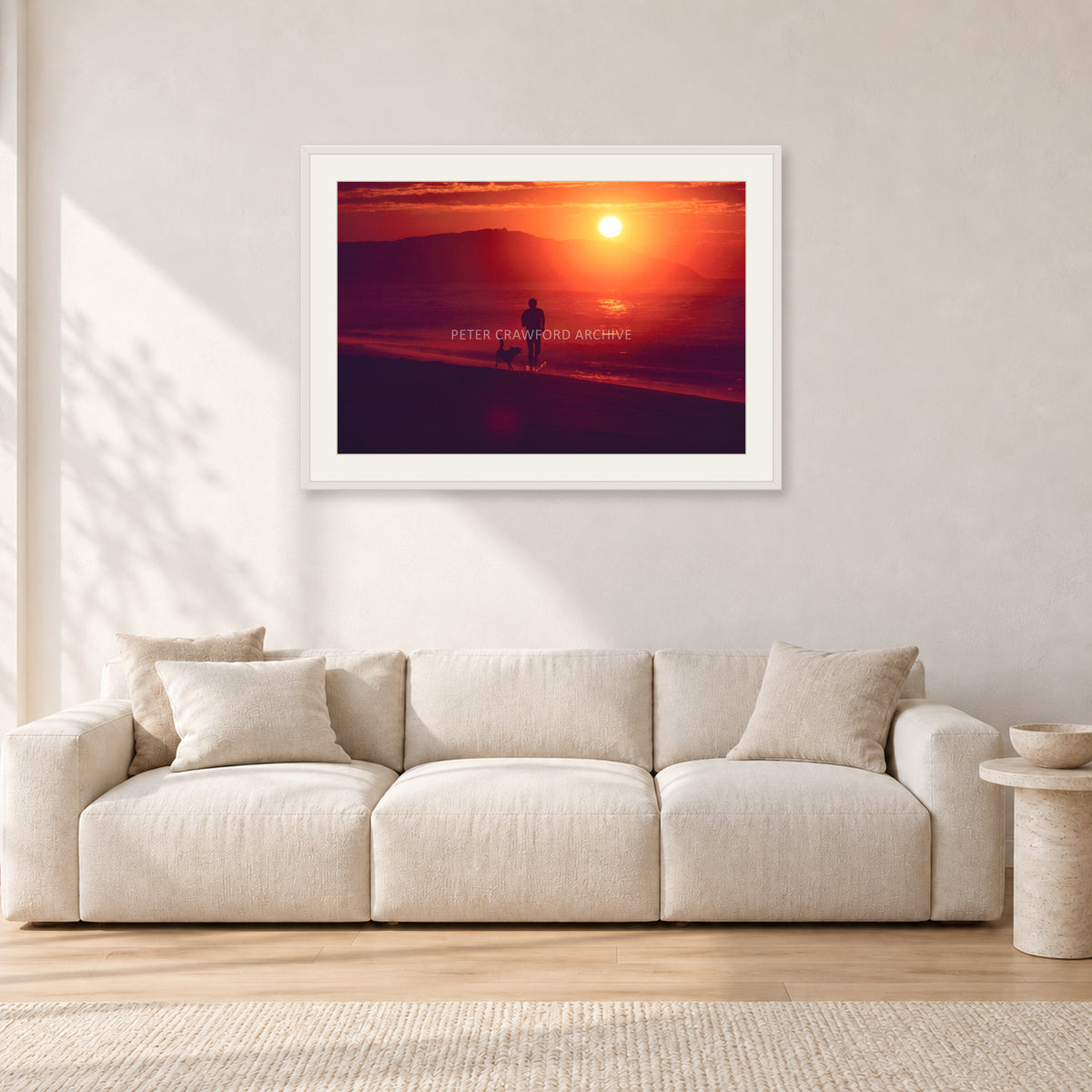 Winter Sun, Collaroy by Peter Crawford — 90 × 60 cm, white frame with white mat, shown in a light minimalist living room.